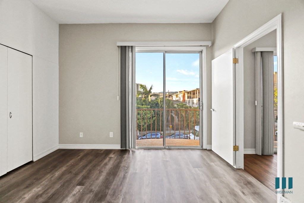 Bedroom with Closet, Balcony with Double Glass Doors, and Vinyl Flooring