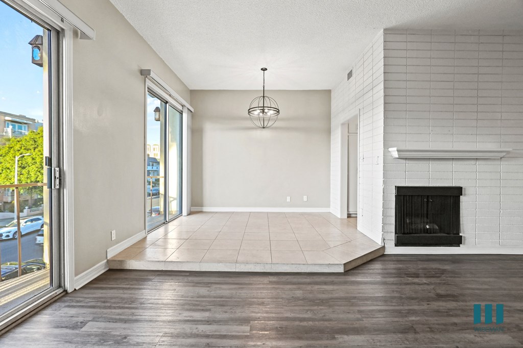 Open-Concept Living Room and Dining Room Space with Balcony and Double Glass Doors