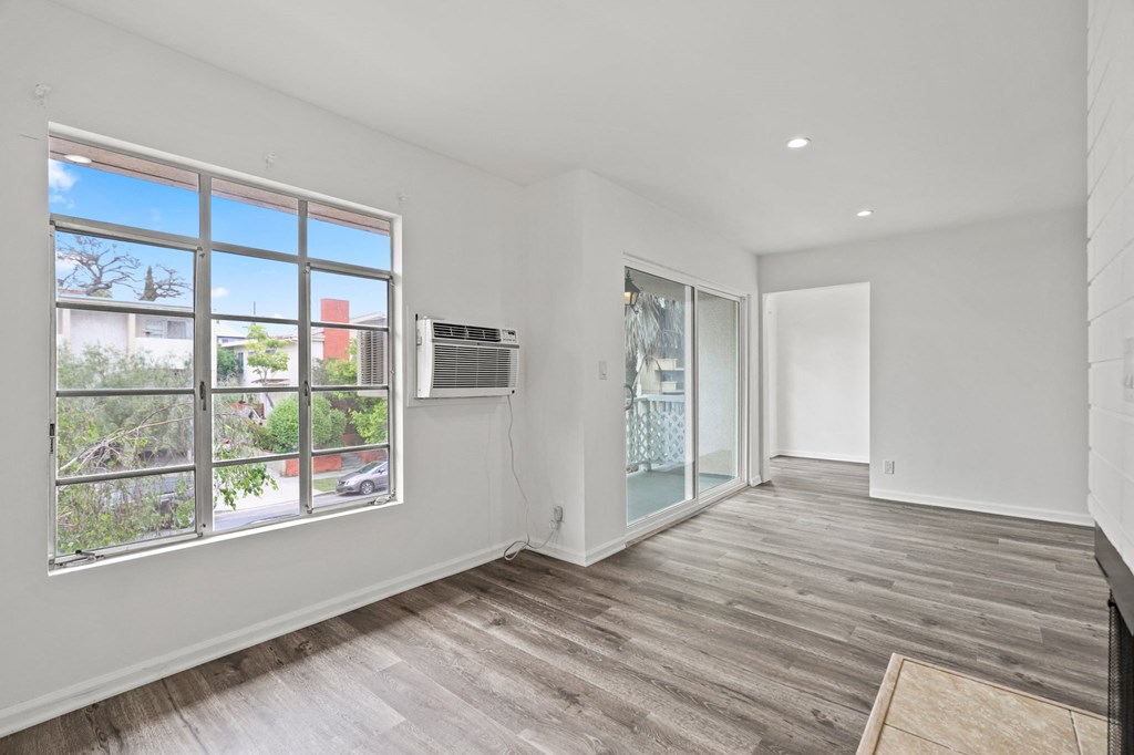 Living Room with Electric Fireplace, Recessed Lighting, Vinyl Flooring, and Patio