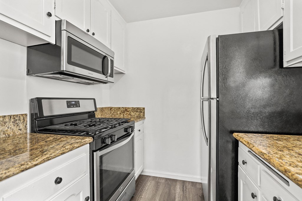 Kitchen with Stainless-Steel Refrigerator, Stove, and Microwave Oven