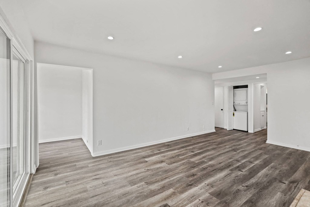 Living Room with Vinyl Flooring, Recessed Lighting. and In-Suite Washer & Dryer