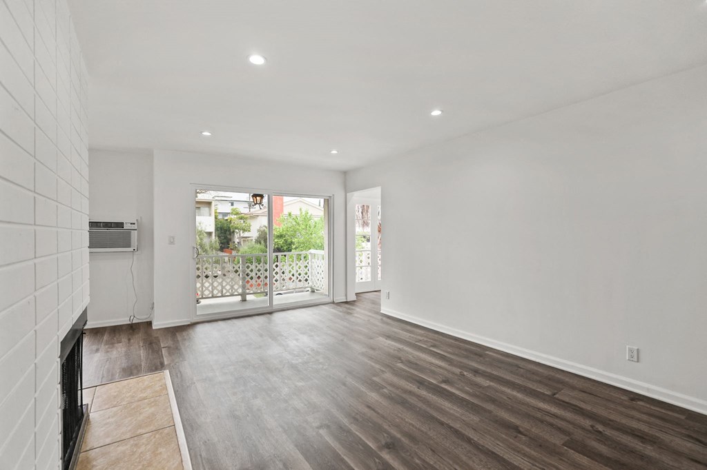 Living Room with Electric Fireplace, Recessed Lighting, Vinyl Flooring, and Patio