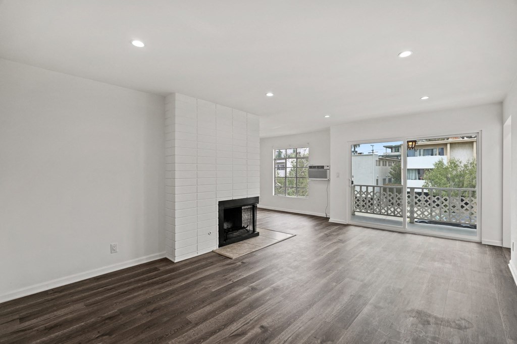 Open-Concept Living Room and Dining Room with an Electric Fireplace and Patio