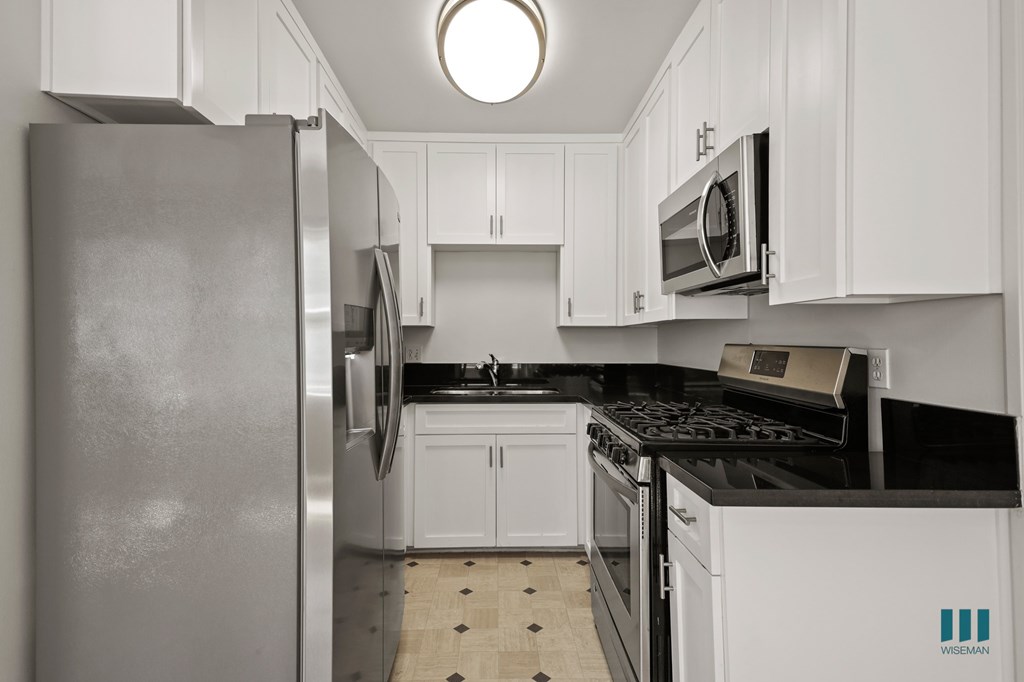 Kitchen with Stainless-Steel Refrigerator, Stove, Microwave Oven, and Ample Cabinet Storage