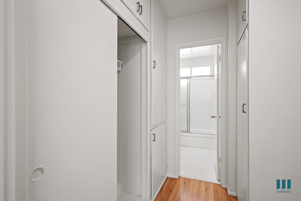 Hallway with Cabinet Storage and Bathroom