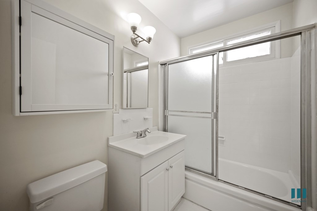 Bathroom with Shower Bath and a Glass Door