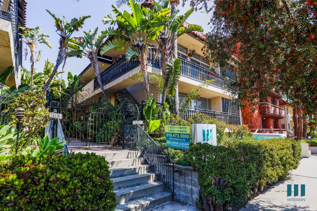 an apartment building with a staircase in front of it