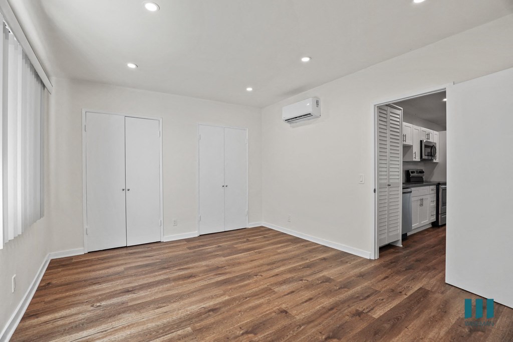 Bedroom with Multiple Closets, Vinyl Flooring, and Recessed Lighting