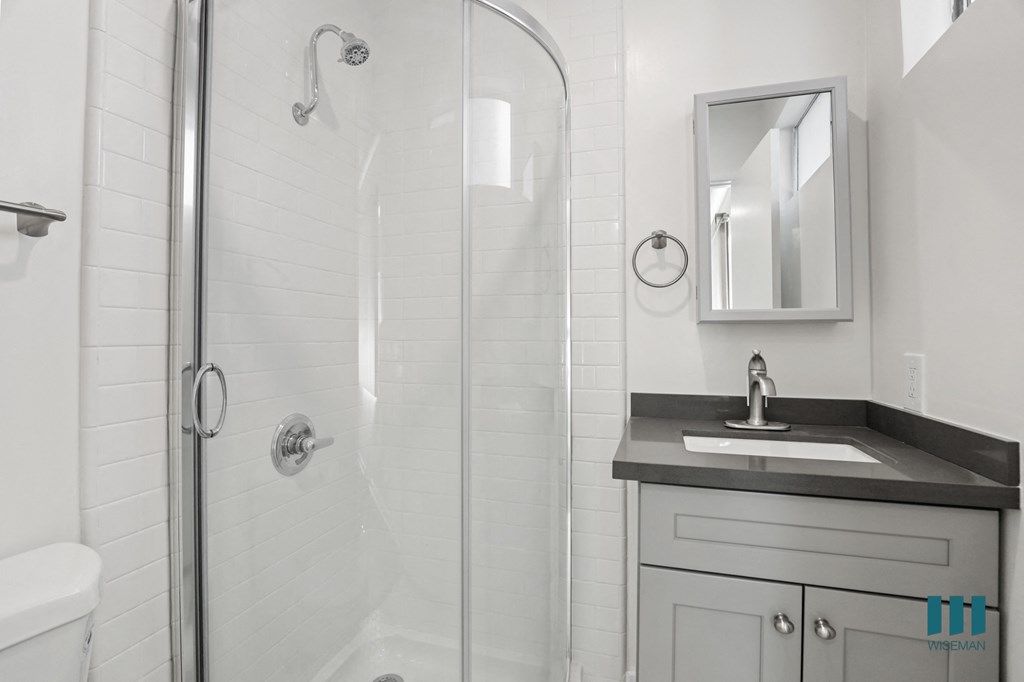 Bathroom with Stand-Up Shower and Glass Door and Vanity Cabinet Storage