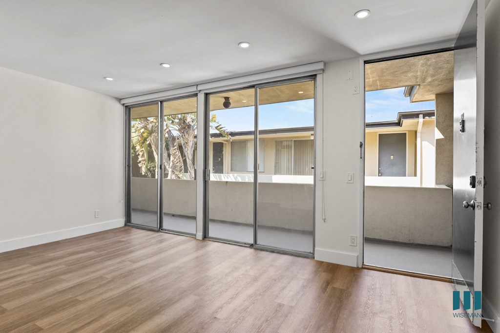 Front Entrance and Living Room with Sliding Glass Doors to Balcony