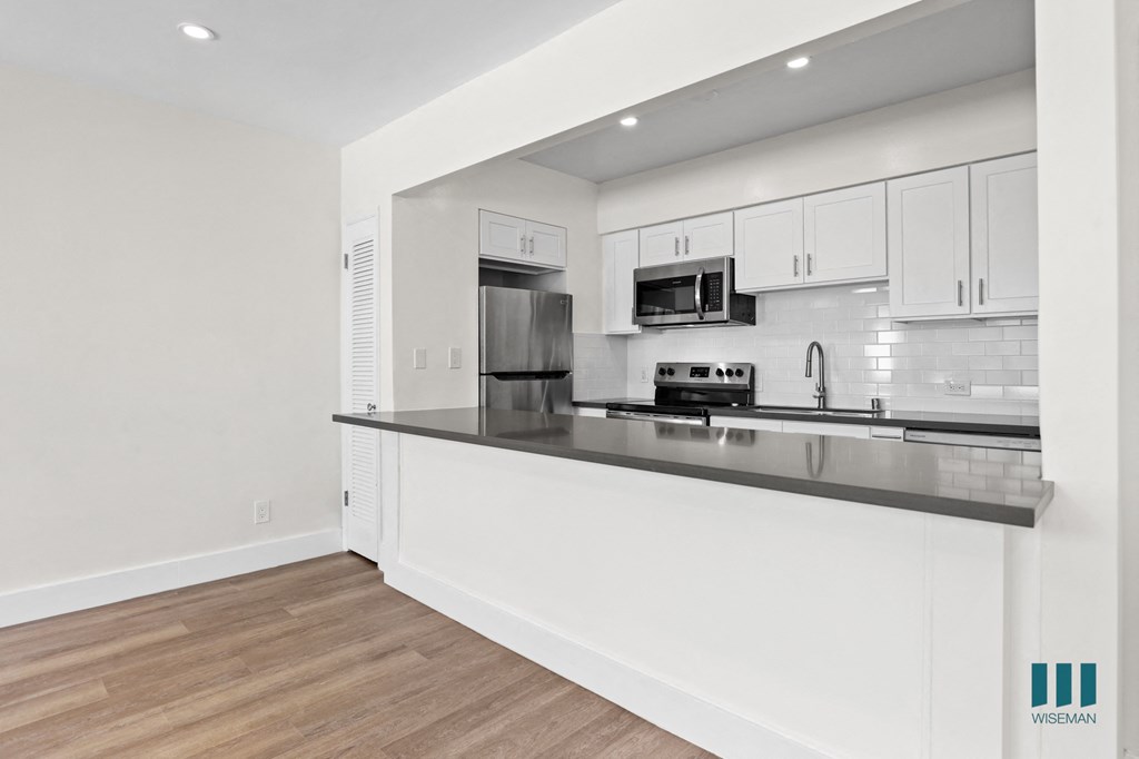 Kitchen with Energy-Efficient Appliances and Countertop Bar