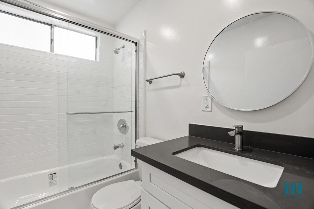 Bathroom with Shower Bath with Glass Door and Vanity Cabinet Storage
