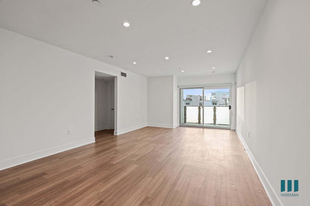 Open-Concept Dining, Living Room, and Patio with Recessed Lighting and Vinyl Flooring