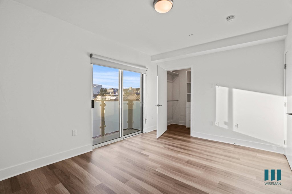 Bedroom with Patio, Walk-In Closet, and Vinyl Flooring