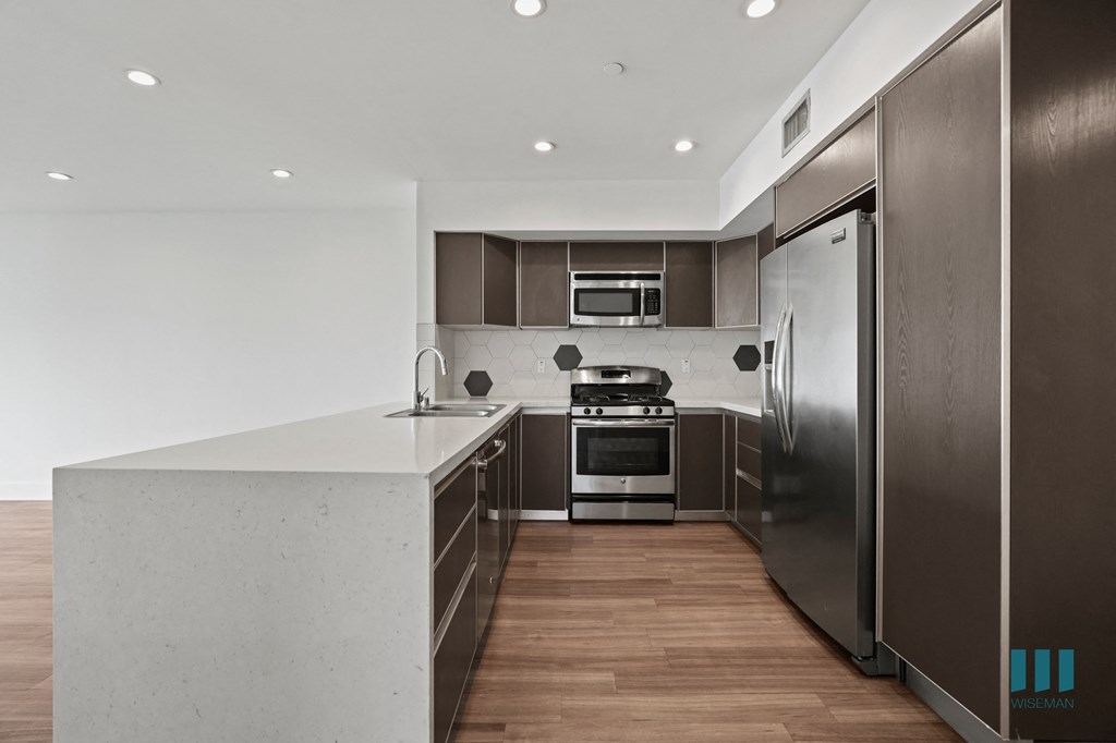 Full-Size Kitchen with Stainless-Steel Refrigerator, Stove, Microwave Oven, and Dishwasher