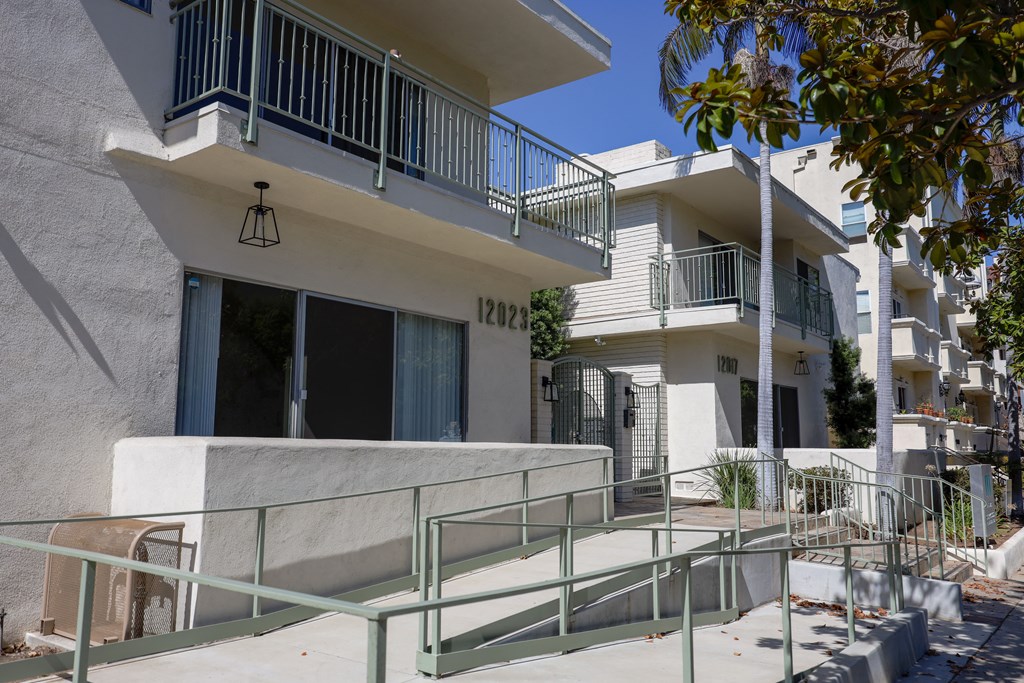 an apartment building with a staircase in front of it