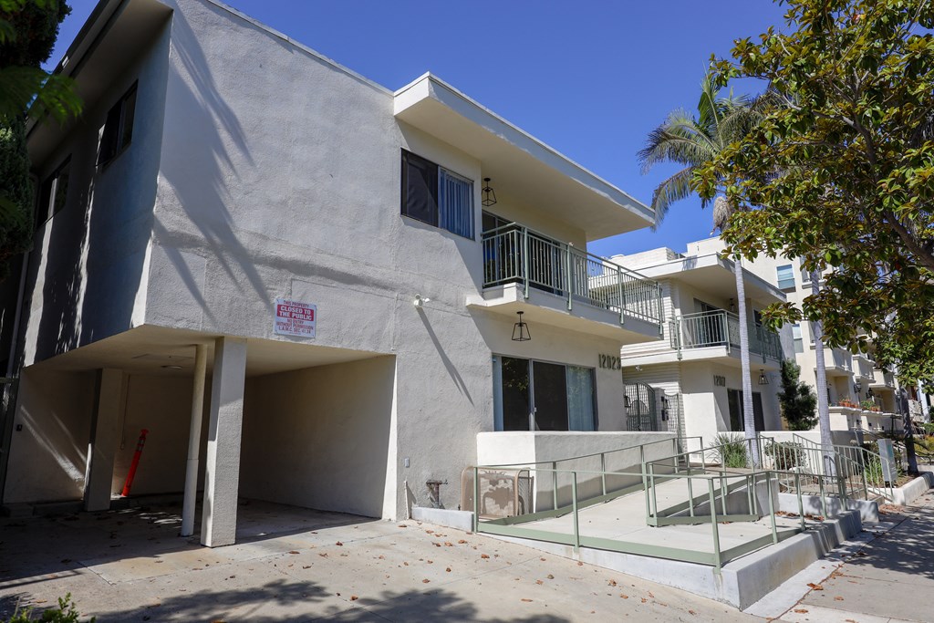the exterior of a building with a staircase and a glass door