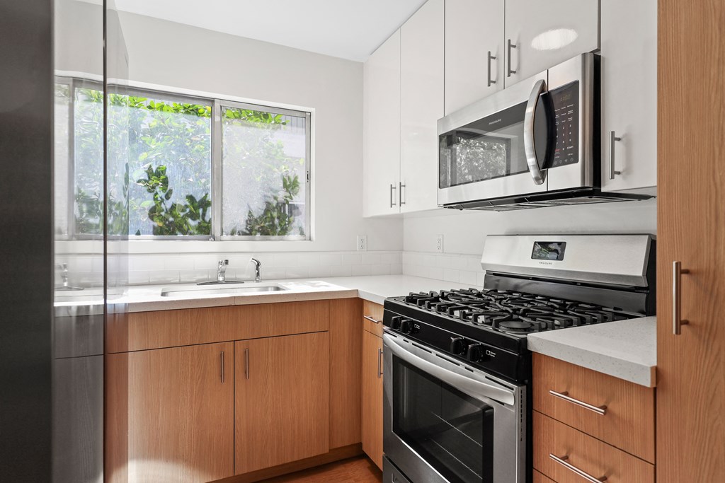 a kitchen with stainless steel appliances and wooden cabinets