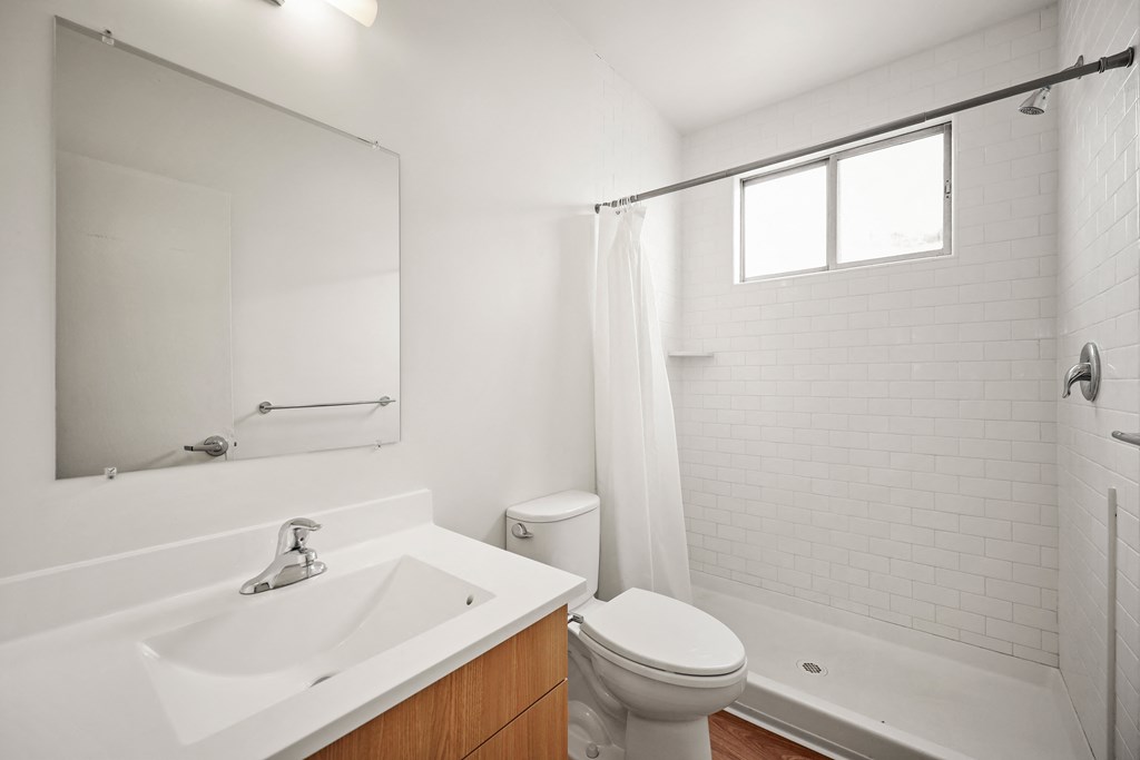 a bathroom with a sink toilet and a mirror