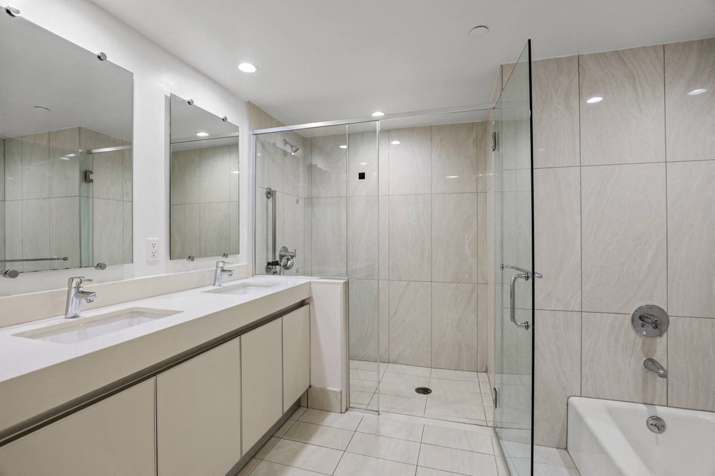 Bathroom with a Full-Size Bathtub, Shower, and Double-Sink Vanity