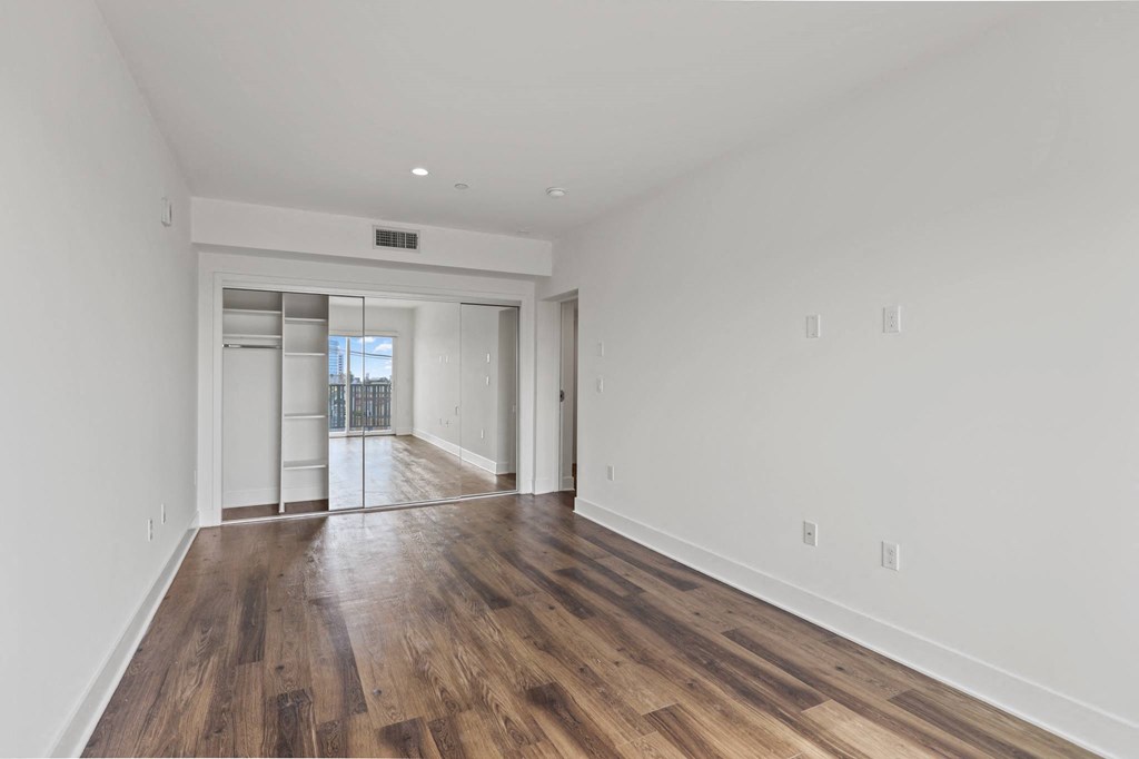 Bedroom with Large-Size Mirrored Closet with Shelving