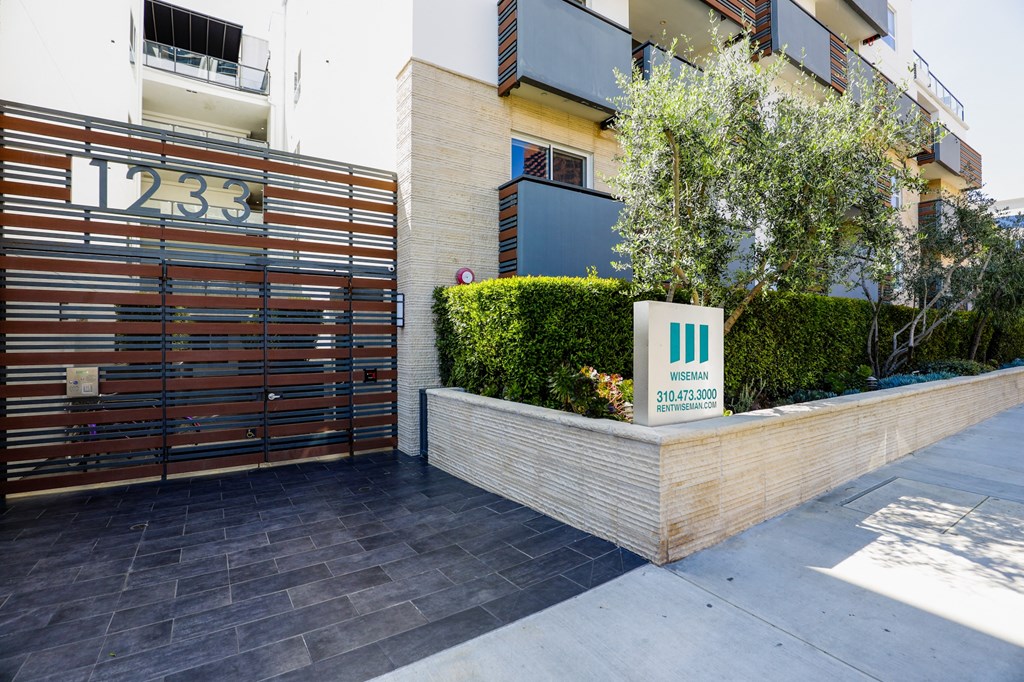 an image of the entrance to a building with a sign that reads 1233