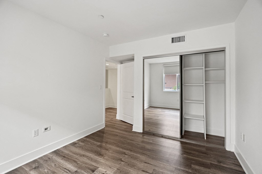 Bedroom with Mirrored Closet with Shelving
