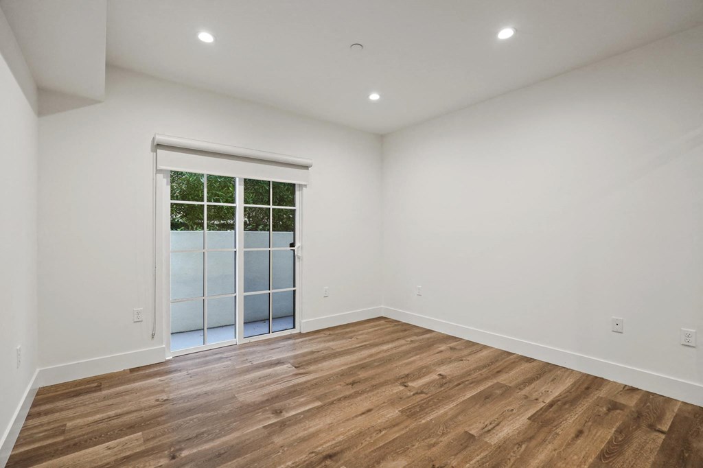 Bedroom with Balcony, Vinyl Flooring, and Recessed Lighting