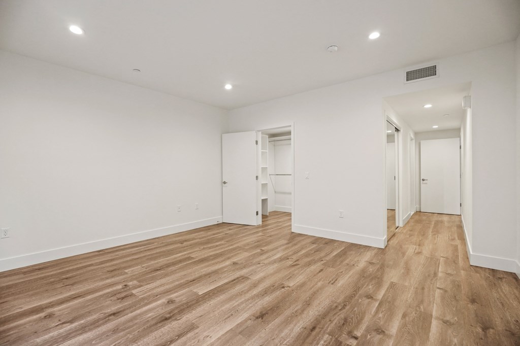 Bedroom with Two Closets, Bathroom, and Vinyl Flooring