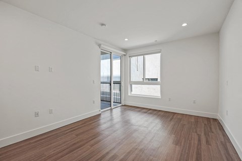 Bedroom with Recessed Lighting, Vinyl Floors, Windows, and Patio