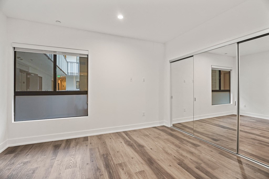 Bedroom with Large-Size Mirrored Closets