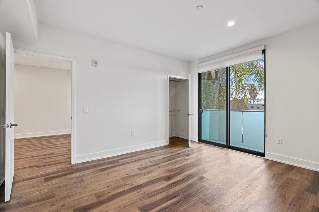 Bedroom with Recessed Lighting, Vinyl Flooring, and Balcony