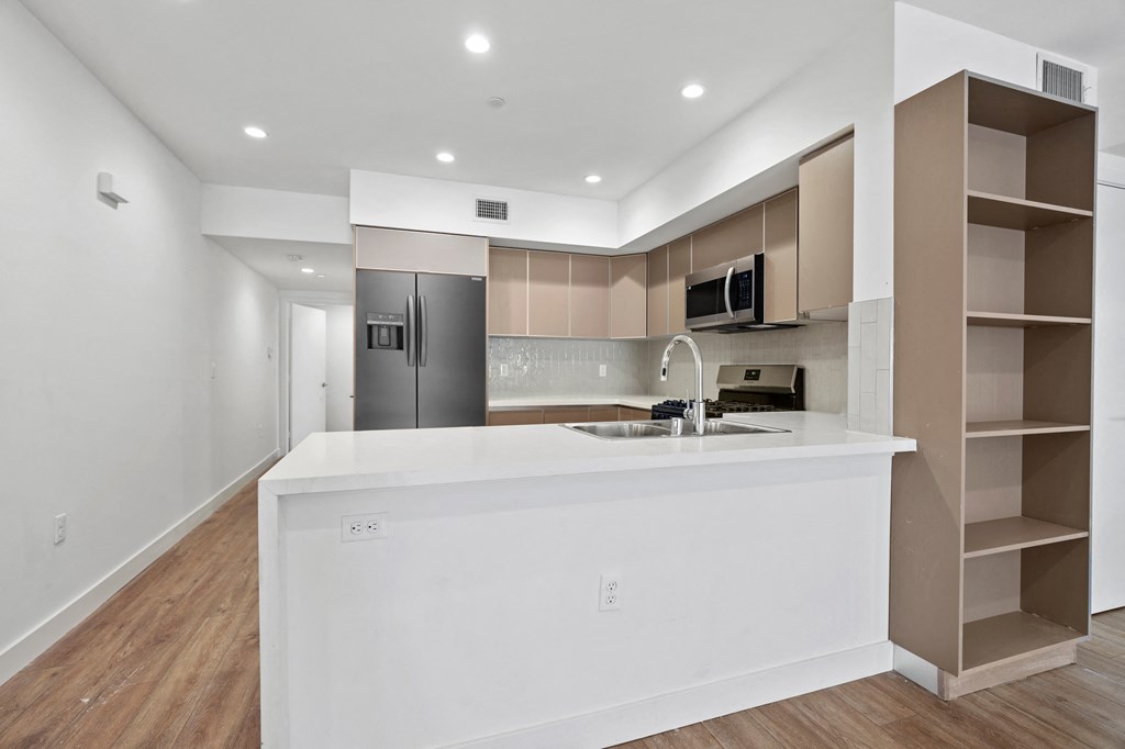 Open-Concept Kitchen with Countertop Bar and Dining Area with Built-In Shelving