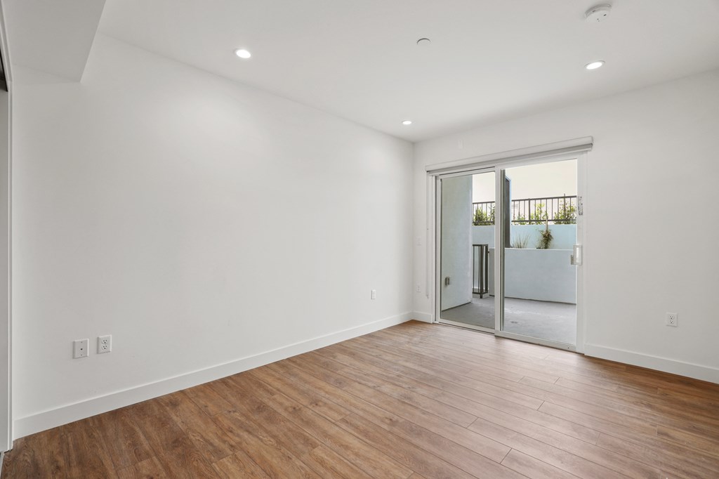 Bedroom with Recessed Lighting, Vinyl Flooring, and Patio