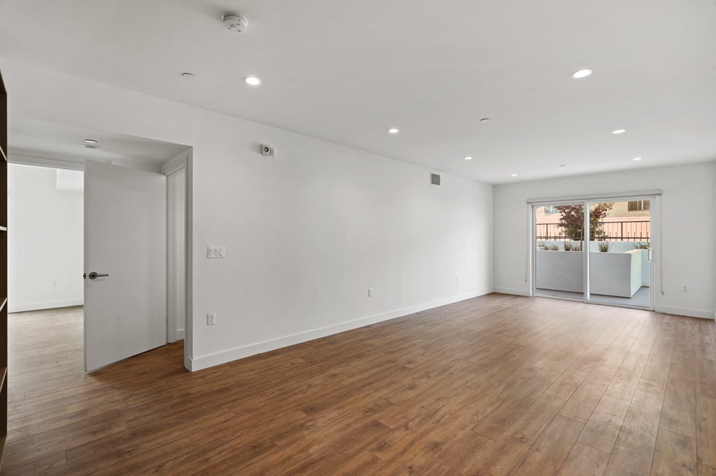 Large-Size Living Room with Vinyl Flooring, Recessed Lighting, and Patio