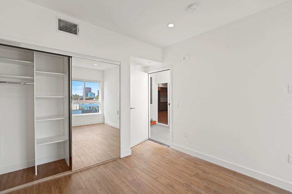 Bedroom with Mirrored Closet with Shelving