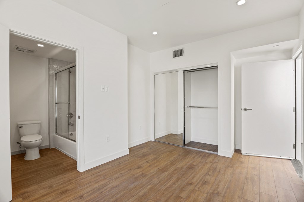 Bedroom with a Mirrored Closet and Bathroom