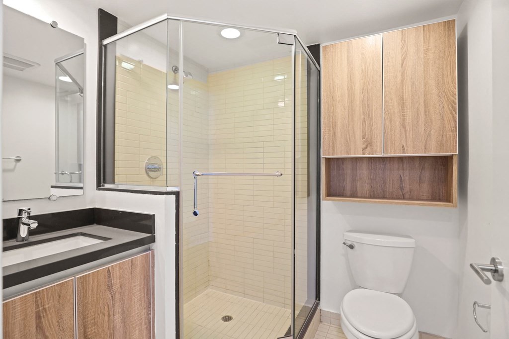 Bathroom with Stand-Up Shower with Glass Door and Cabinet Storage