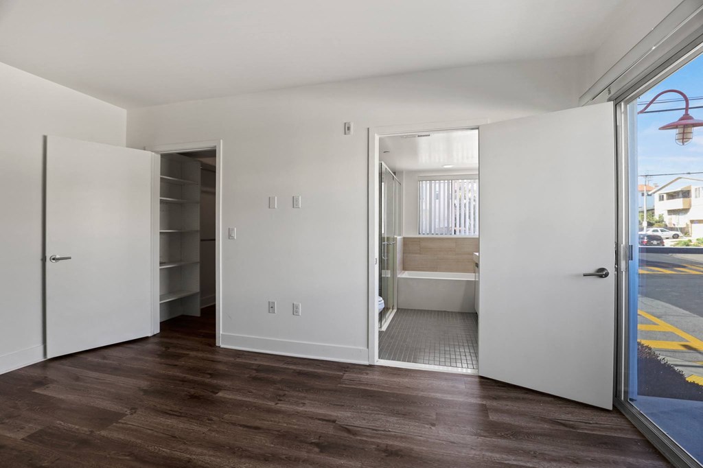 Bedroom, Walk-In Closet with Shelving, Bathroom, and Balcony