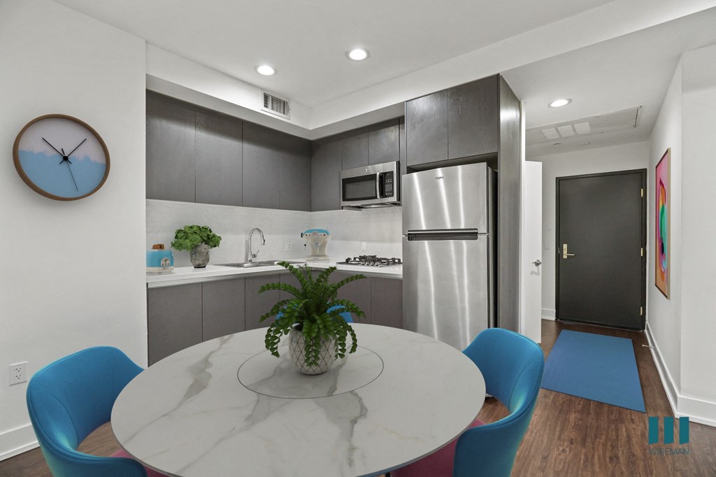 Kitchen with Stovetop, Microwave Oven, Refrigerator, and Dining Area