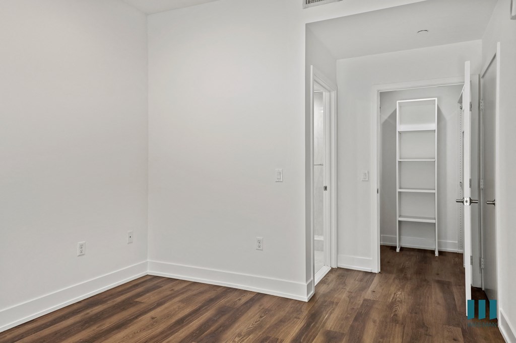Bedroom with Closet with Built-In Shelving
