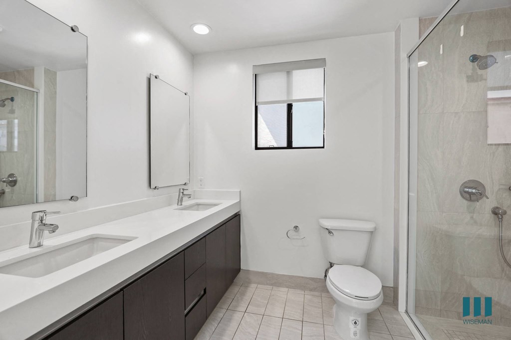 Bathroom with Double-Sink Vanity and Walk-In Shower with Glass Door