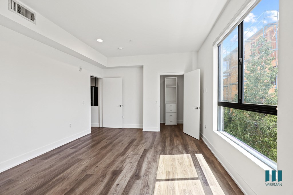 Master Suite with Large-Size Windows, Vinyl Flooring, Recessed Lighting, and Walk-In Closet