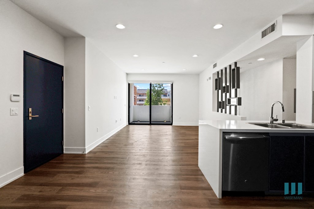 Front Entrance and Open-Concept Kitchen, Dining, and Living Room Space with Patio