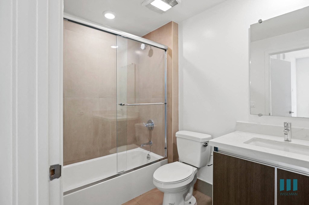 Bathroom with Shower Bath with Glass Door and Vanity Cabinet Storage