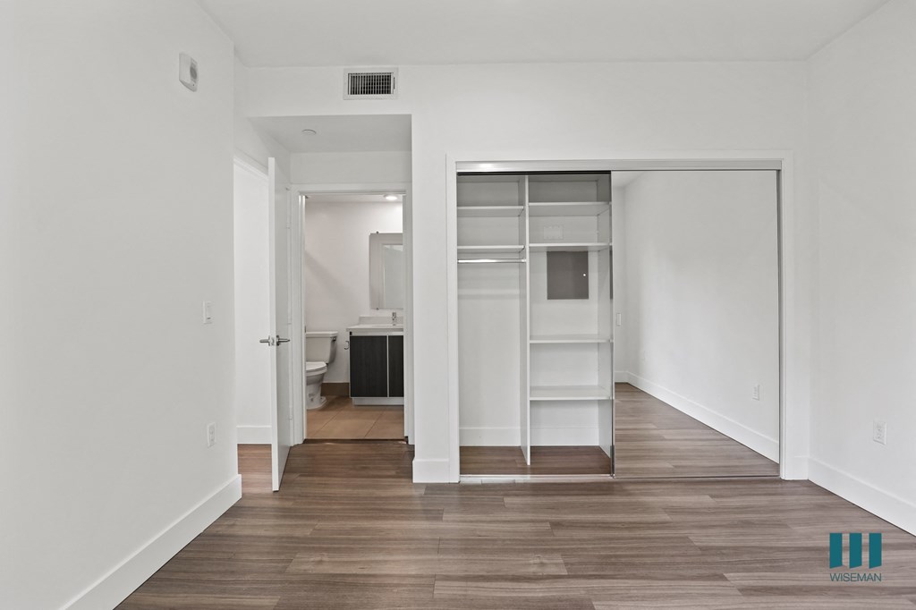 Bedroom with Mirrored Closet with Shelving