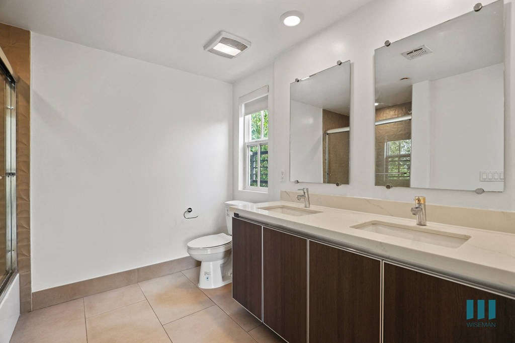 Bathroom with Double-Sink Vanity and Shower Bath with Glass Door