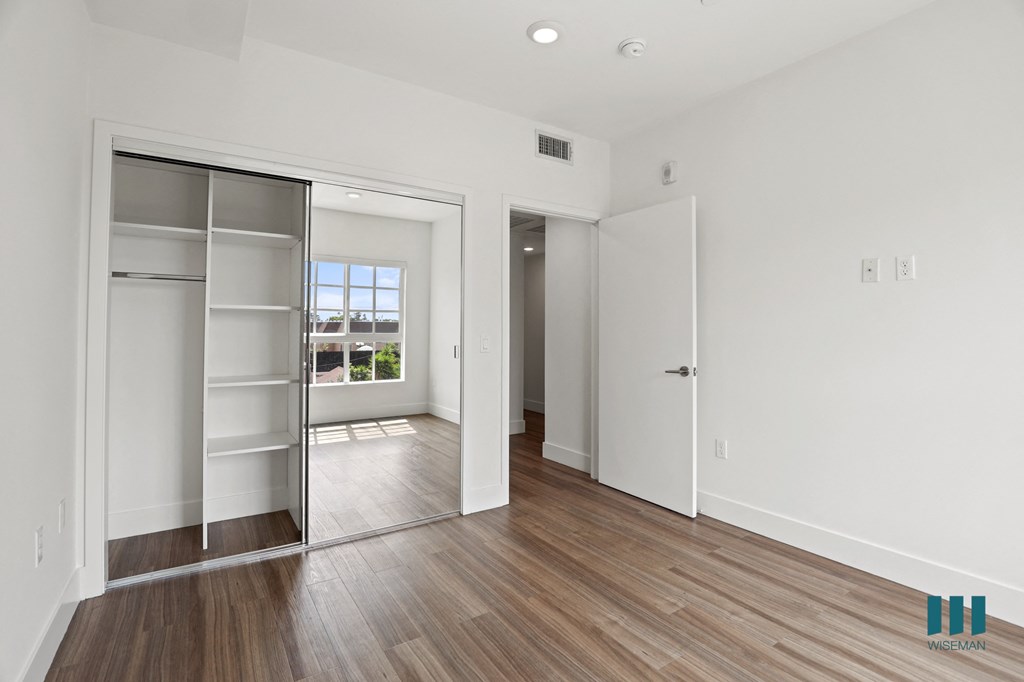 Bedroom with Mirrored Closet with Shelving