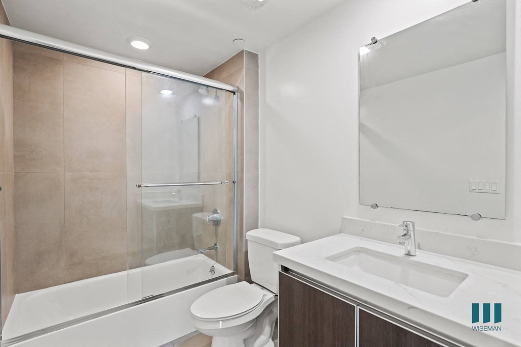 Bathroom with Shower Bath with Glass Door and Vanity Cabinet Storage