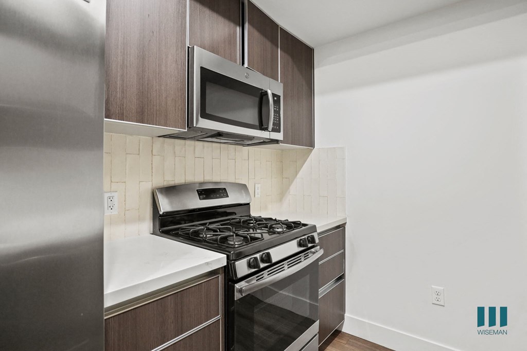 Kitchen with Stainless Refrigerator, Stove, and Microwave Oven